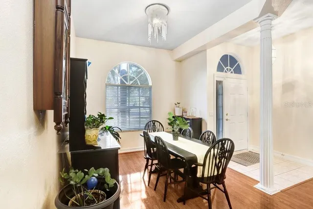 a view of a dining room with furniture and chandelier
