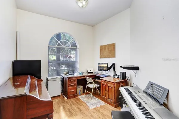 a view of a workspace with furniture and a flat screen tv