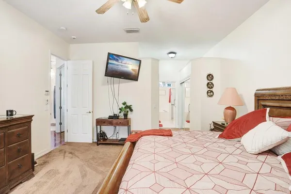 a bedroom with a bed and a chandelier