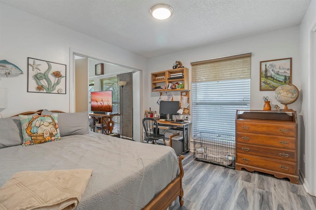 17 Townhouse Lane Trinity, TX 75862 - Photo 20 of 26 a bedroom with a bed and wooden floor