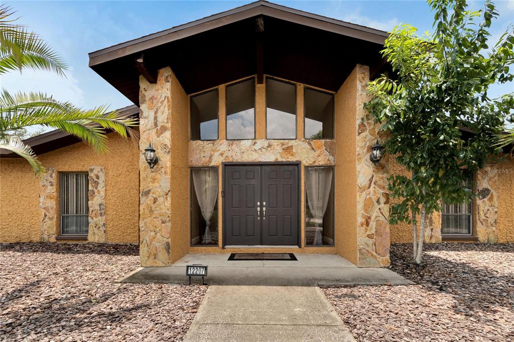 a black car parked in front of a house