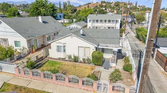 an aerial view of a house with a garden and plants