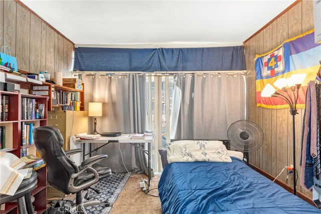 a living room with furniture and a dining table with wooden floor