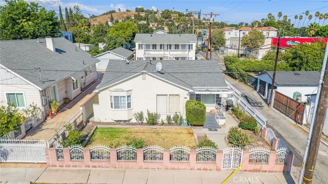 an aerial view of a house with a yard