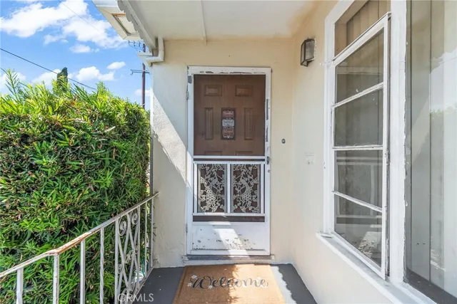 a bedroom with a bed and a flat tv screen on the dresser