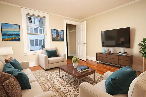 a living room with furniture and a flat screen tv
