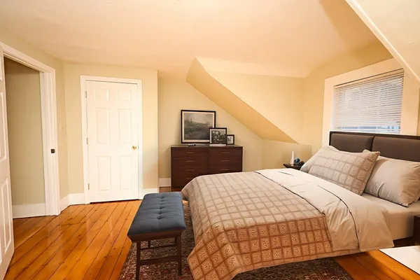 a bedroom with a bed and a night stand