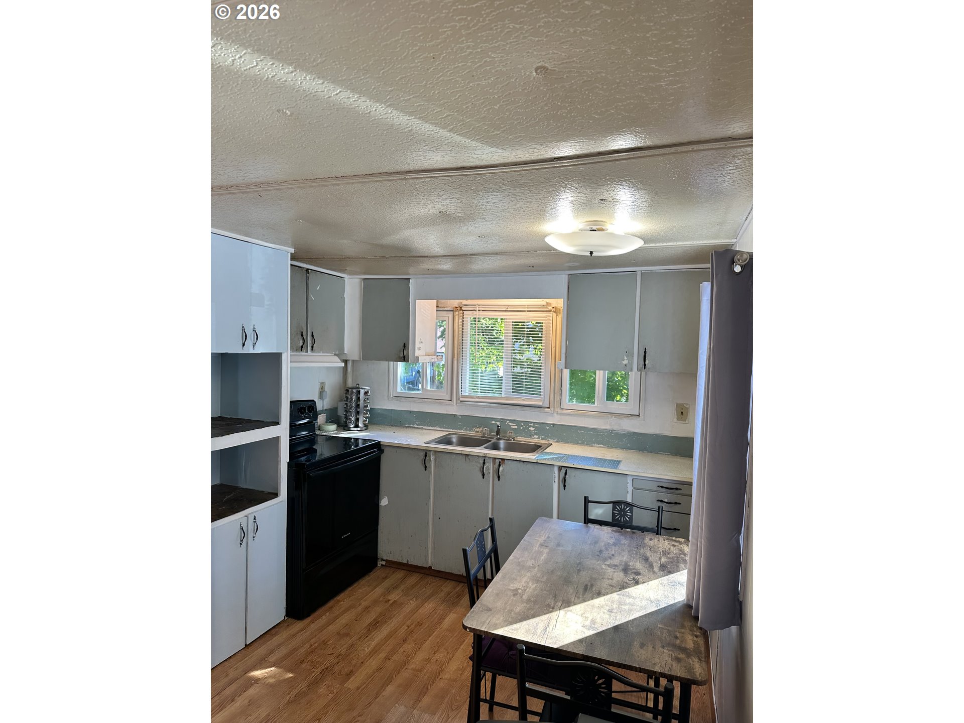 37635 Row River Road, Unit 7 Dorena, OR 97434 - Photo 6 of 27 a kitchen with a sink cabinets and window