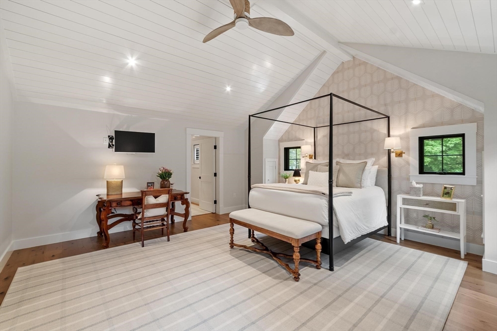 653 Main Street Concord, MA 01742 - Photo 25 of 42 a bedroom with a bed and a chandelier