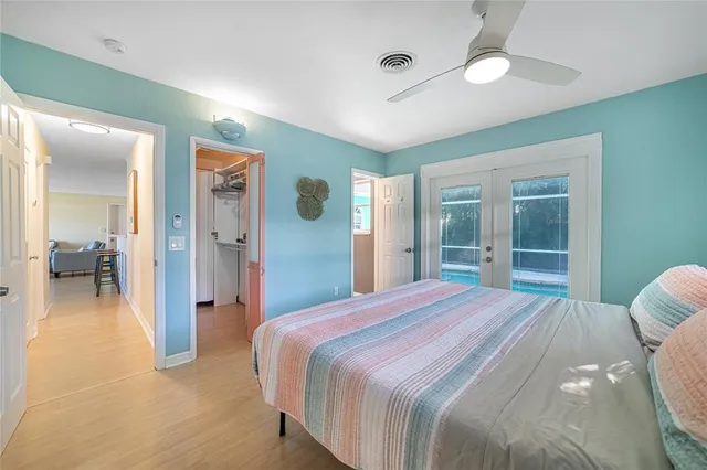 a spacious bedroom with a bed and a large mirror