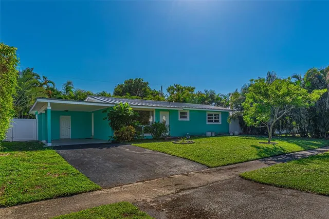 a front view of a house with a yard and trees
