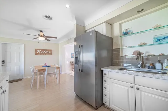 a kitchen with a refrigerator and table