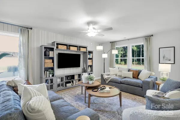 a living room with furniture and a flat screen tv