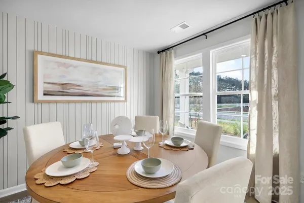 a dining room with furniture a rug and wooden floor