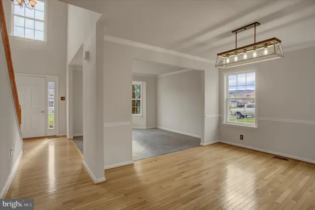 a kitchen with stainless steel appliances granite countertop a sink a stove a refrigerator a center island and cabinets