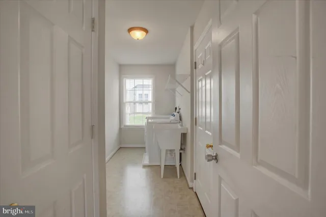 an empty room with closet and a chandelier fan