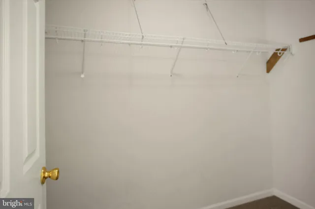 an empty room with a window and a ceiling fan