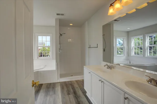a bathroom with a sink toilet vanity and shower