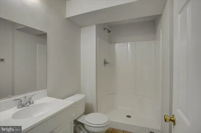 a front view of house with yard and trees in the background