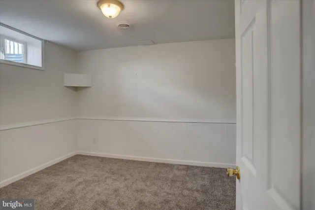 a view of backyard with seating space and wooden fence