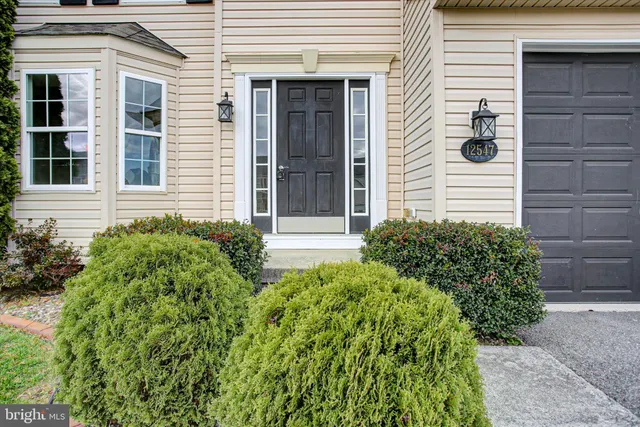 a view of a pathway of the house front of a house