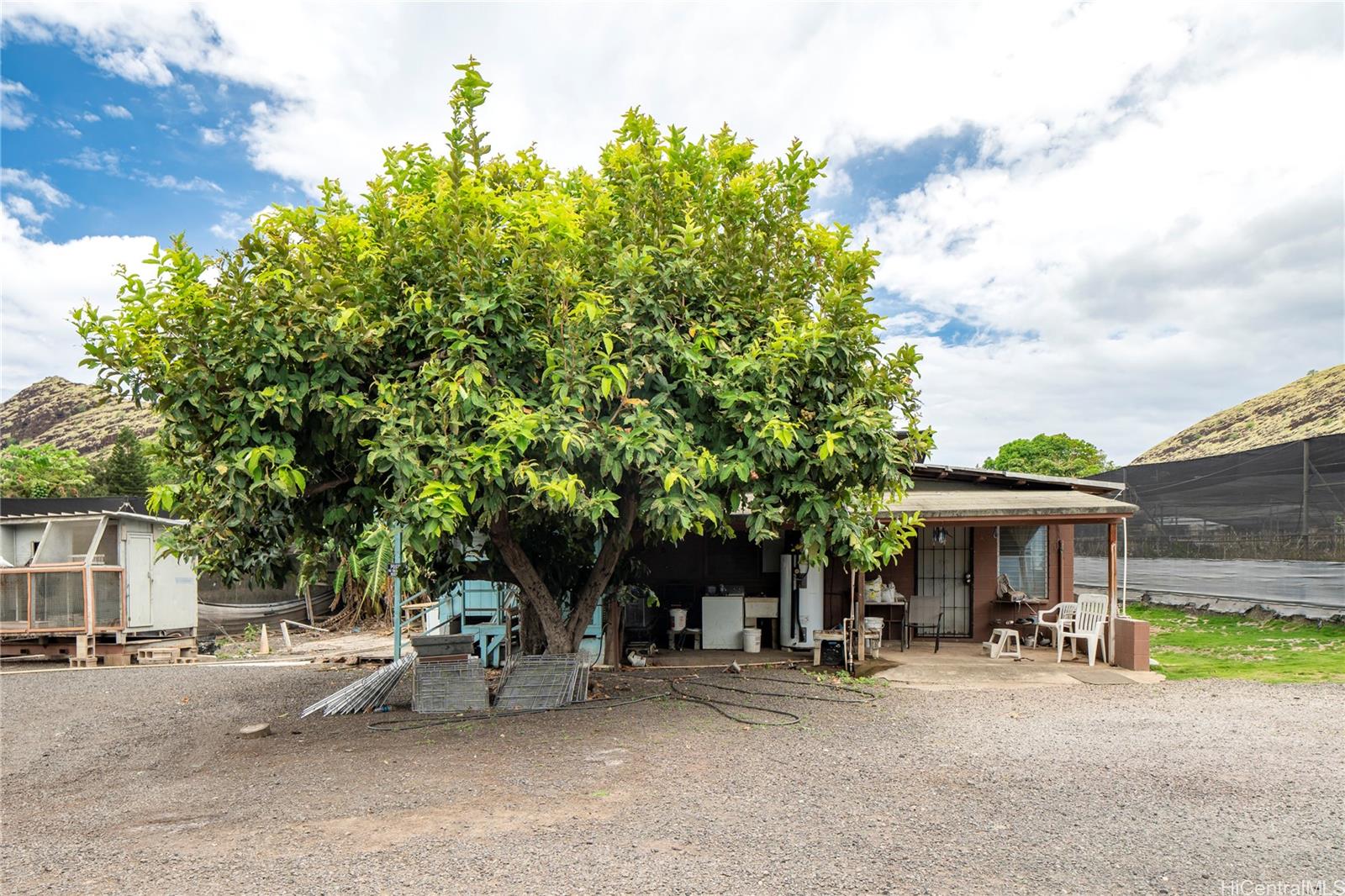 86-347 Halona Road Waianae, HI 96792 - Photo 11 of 22 a view of a patio with table and chairs and potted plants