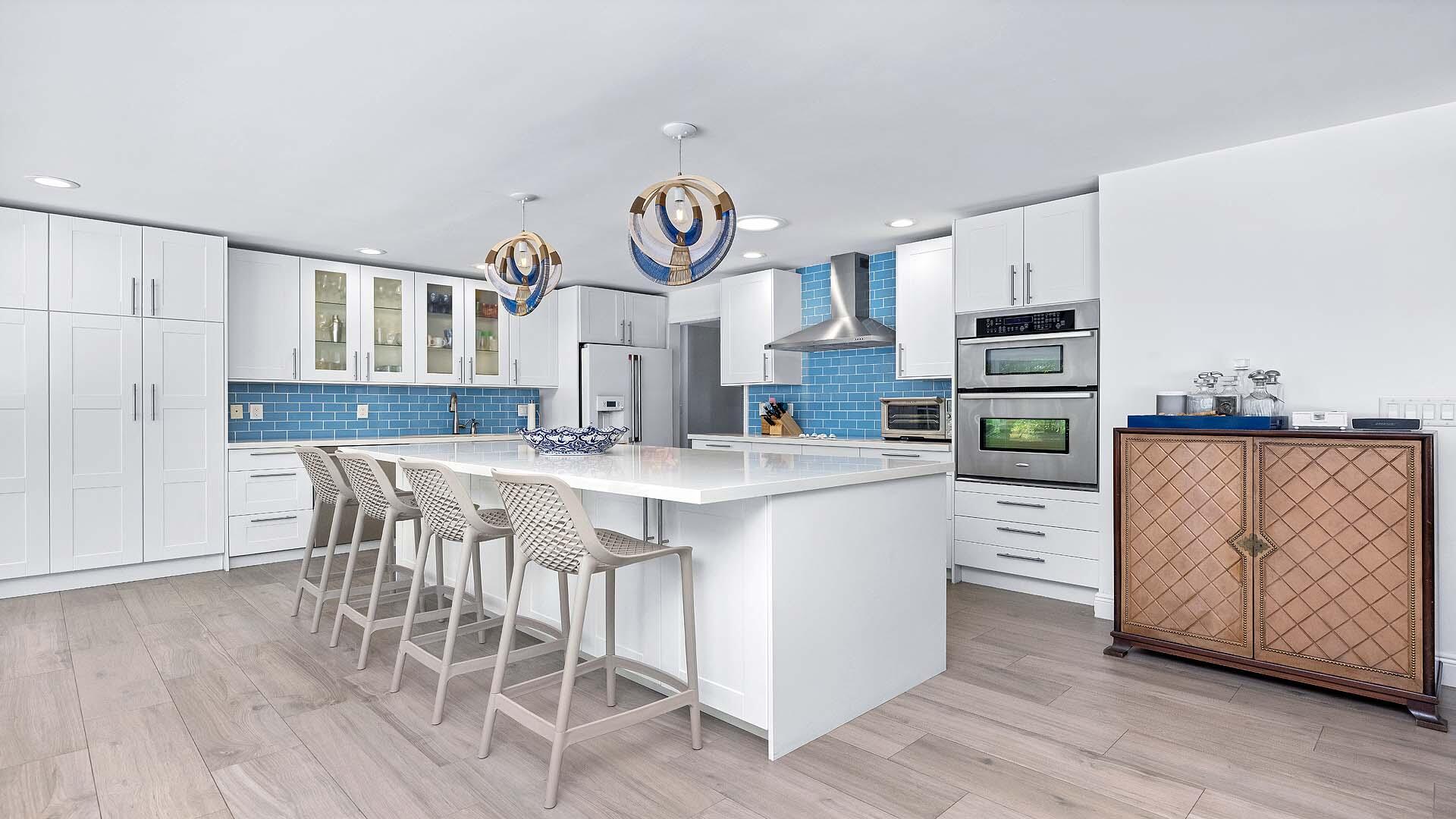 335 Old School Road Gulf Stream, FL 33483 - Photo 12 of 29 a kitchen with stainless steel appliances granite countertop a kitchen island hardwood floor and a sink
