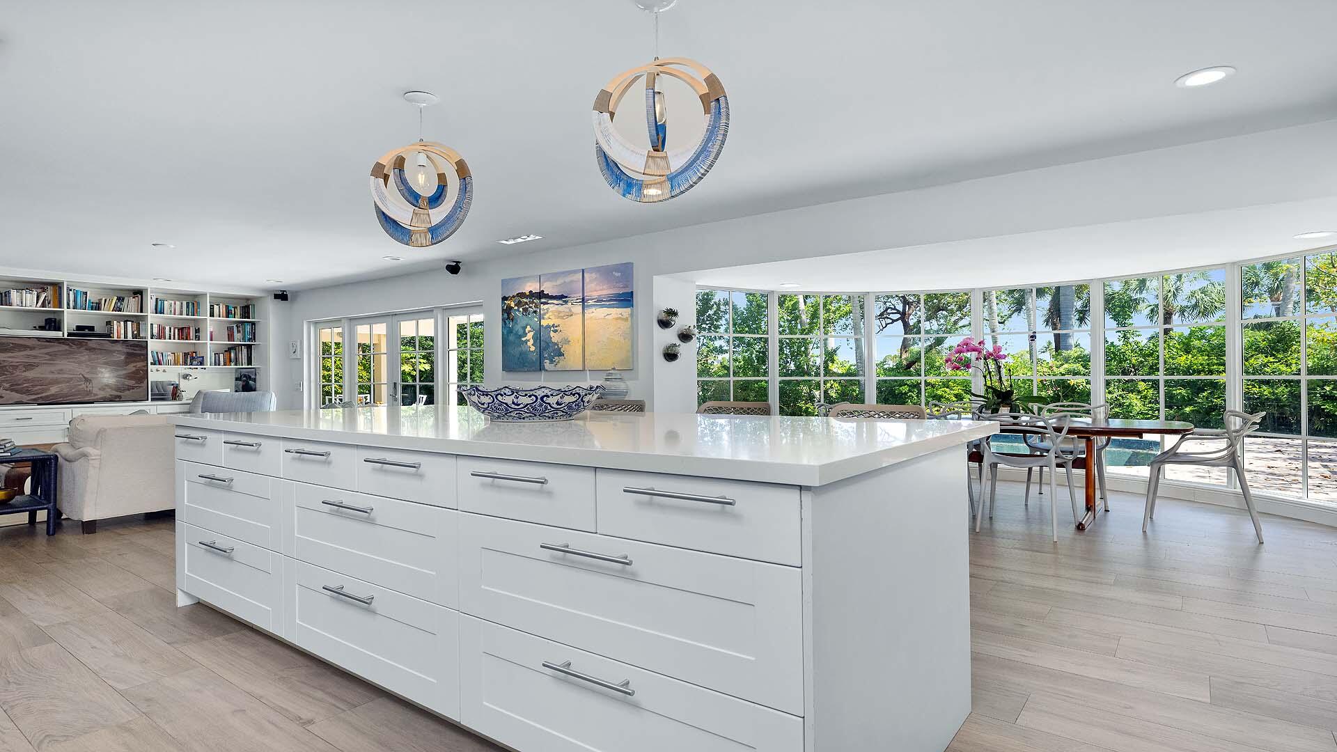 335 Old School Road Gulf Stream, FL 33483 - Photo 14 of 29 a kitchen with a wooden floor and a large window