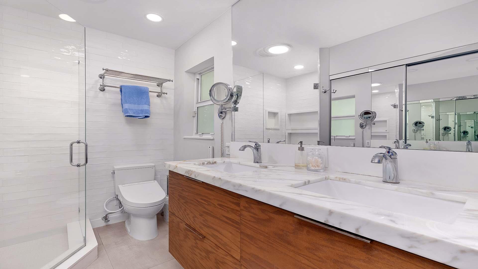 335 Old School Road Gulf Stream, FL 33483 - Photo 17 of 29 a bathroom with a granite countertop sink mirror and toilet