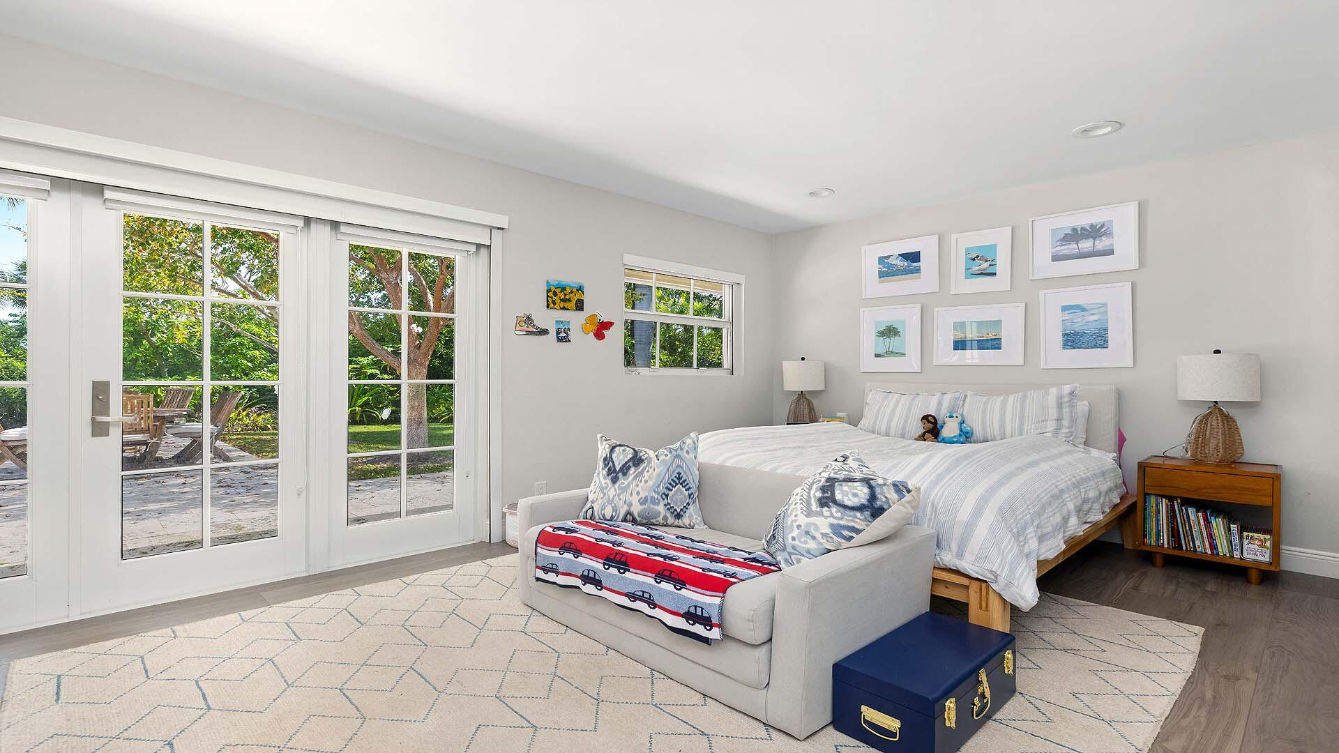 335 Old School Road Gulf Stream, FL 33483 - Photo 18 of 29 a bedroom with a bed and a large window