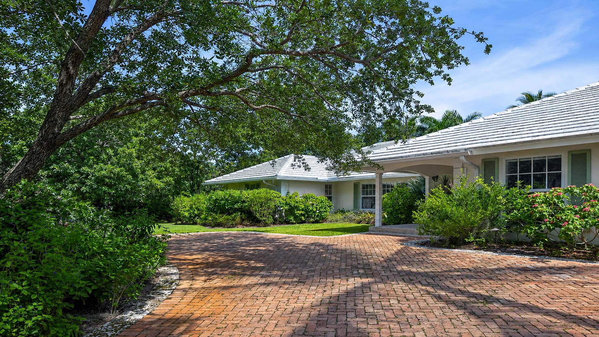 335 Old School Road Gulf Stream, FL 33483 - Photo 6 of 29 a front view of a house with yard and green space