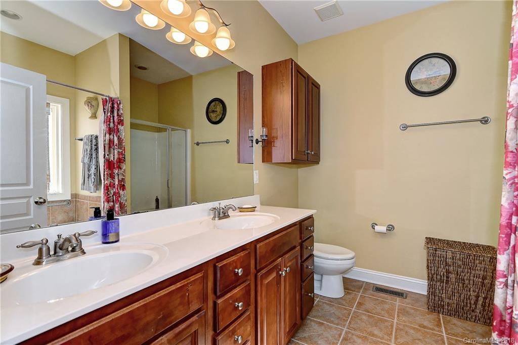 4172 Sunset Ridge Drive Rock Hill, SC 29732 - Photo 18 of 35 a bathroom with a sink a toilet a mirror and shower