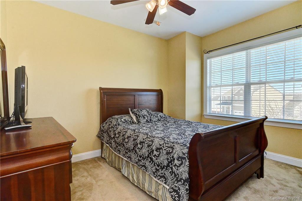 4172 Sunset Ridge Drive Rock Hill, SC 29732 - Photo 23 of 35 a bedroom with a bed and a flat tv screen on dresser