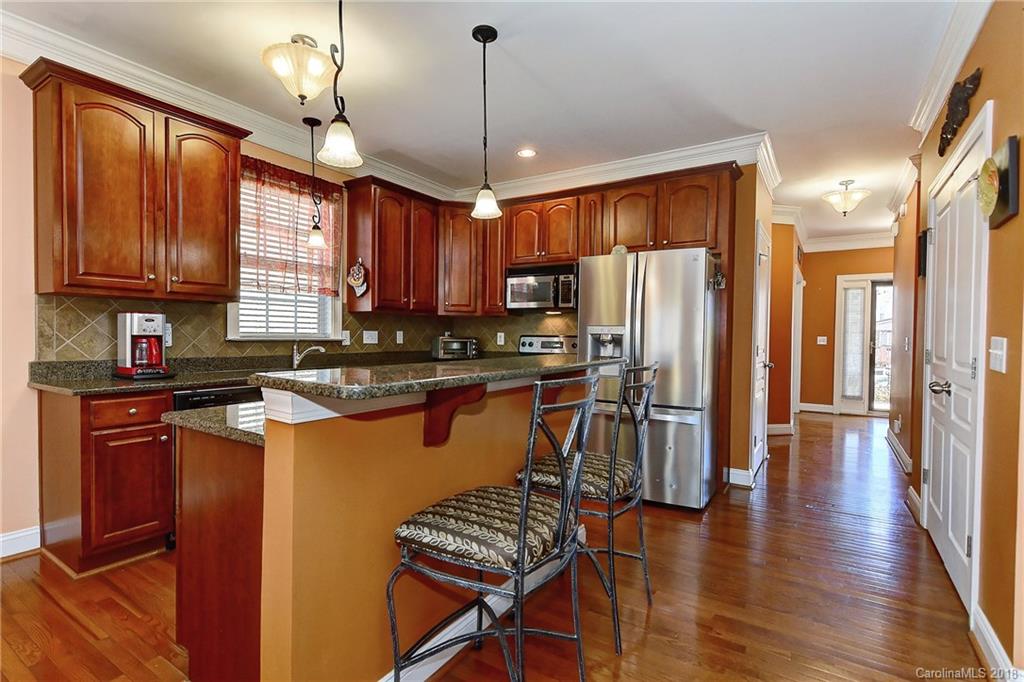 4172 Sunset Ridge Drive Rock Hill, SC 29732 - Photo 6 of 35 a kitchen with stainless steel appliances granite countertop a refrigerator a sink dishwasher a stove and a refrigerator with wooden floor