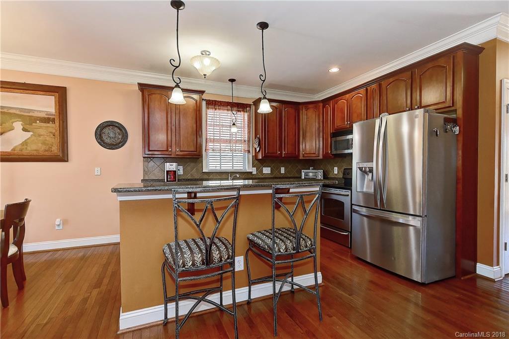 4172 Sunset Ridge Drive Rock Hill, SC 29732 - Photo 7 of 35 a kitchen with stainless steel appliances granite countertop a refrigerator a stove a sink and a wooden cabinets