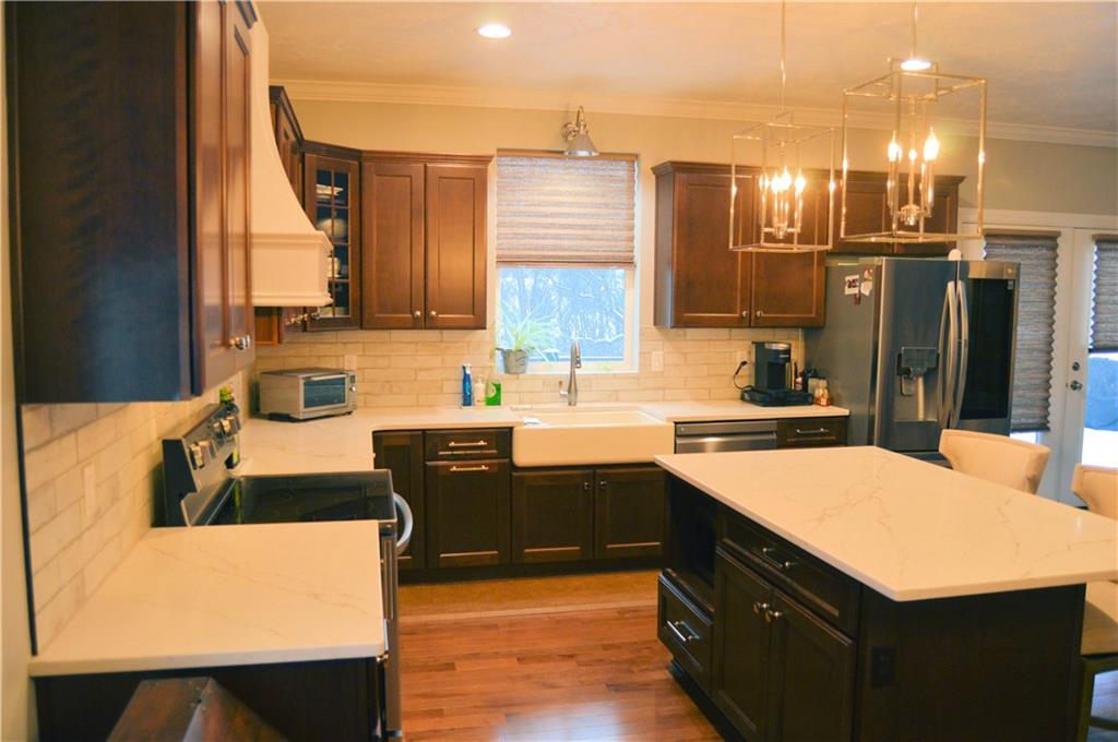 2169 Lovi Road Freedom, PA 15042 - Photo 11 of 25 a kitchen with kitchen island granite countertop a sink counter top space and cabinets