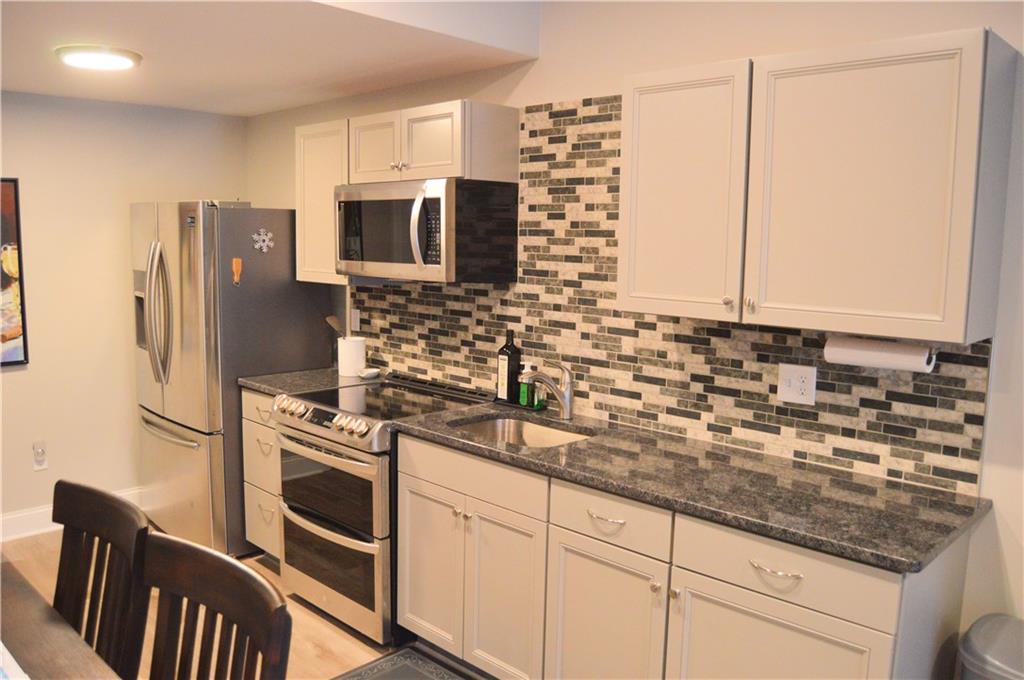 2169 Lovi Road Freedom, PA 15042 - Photo 24 of 25 a kitchen with stainless steel appliances granite countertop a refrigerator stove and sink