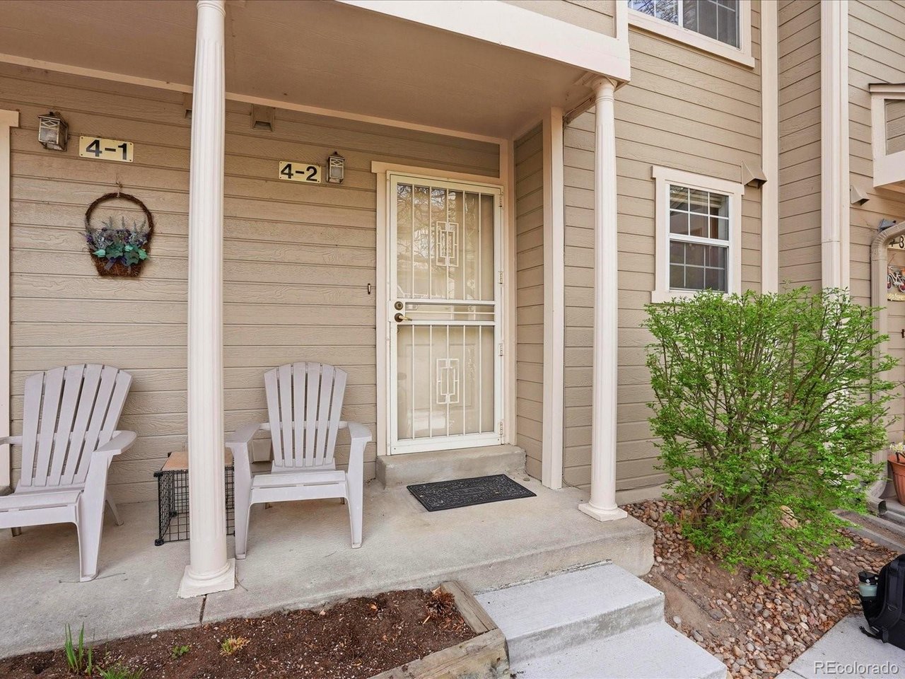 1818 South Quebec Way, Unit 2 Denver, CO 80231 - Photo 2 of 16 a view of porch with a bench and floor to ceiling window