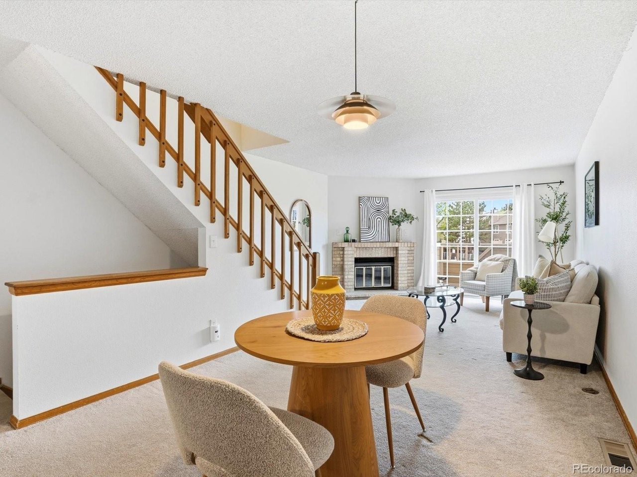 1818 South Quebec Way, Unit 2 Denver, CO 80231 - Photo 3 of 16 a living room with fireplace a table and chairs