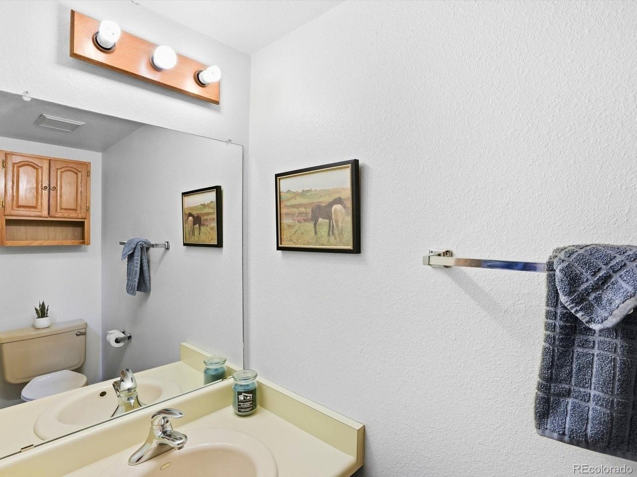 1818 South Quebec Way, Unit 2 Denver, CO 80231 - Photo 8 of 16 a bathroom with a sink and a mirror