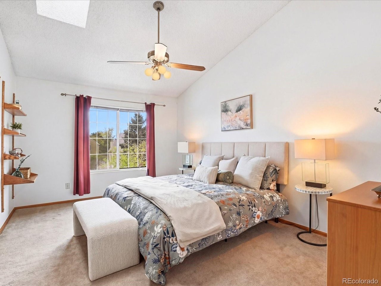 1818 South Quebec Way, Unit 2 Denver, CO 80231 - Photo 9 of 16 a bedroom with a bed and a chandelier