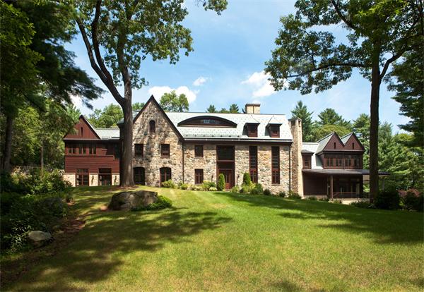 a front view of a house with a yard table and chairs