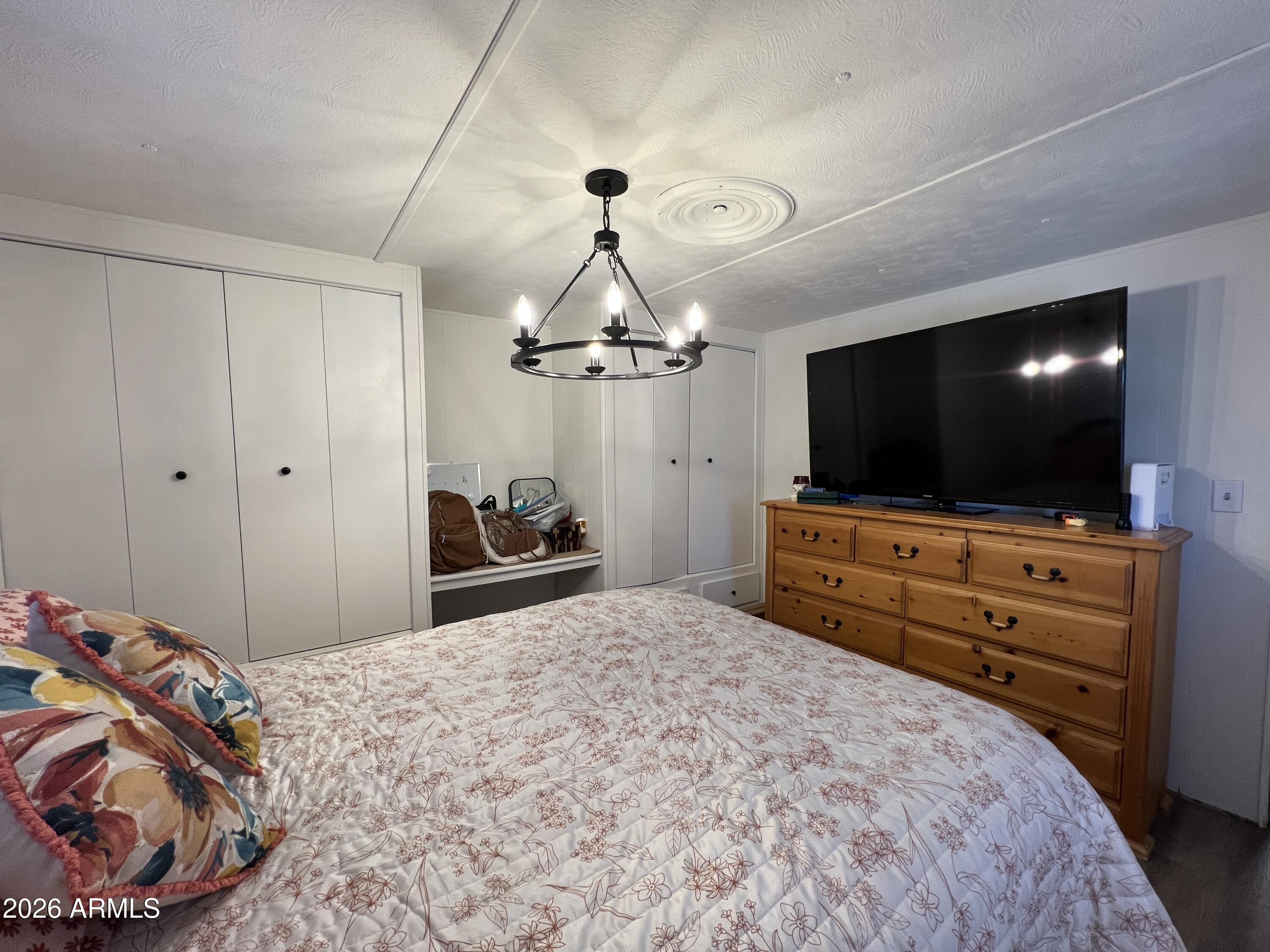 19225 North Cave Creek Road, Unit 40 Phoenix, AZ 85024 - Photo 15 of 21 a bedroom with a bed and a flat screen tv