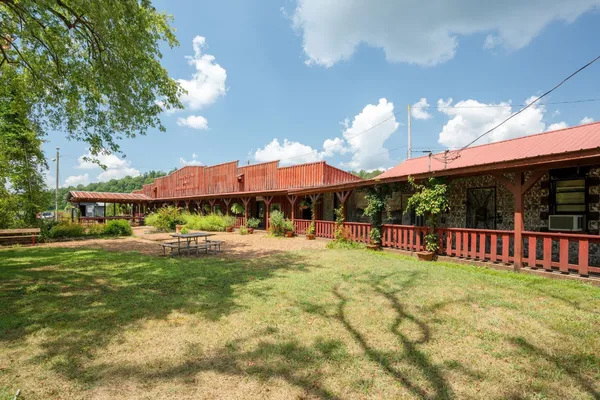 a view of a terrace with a garden and trees