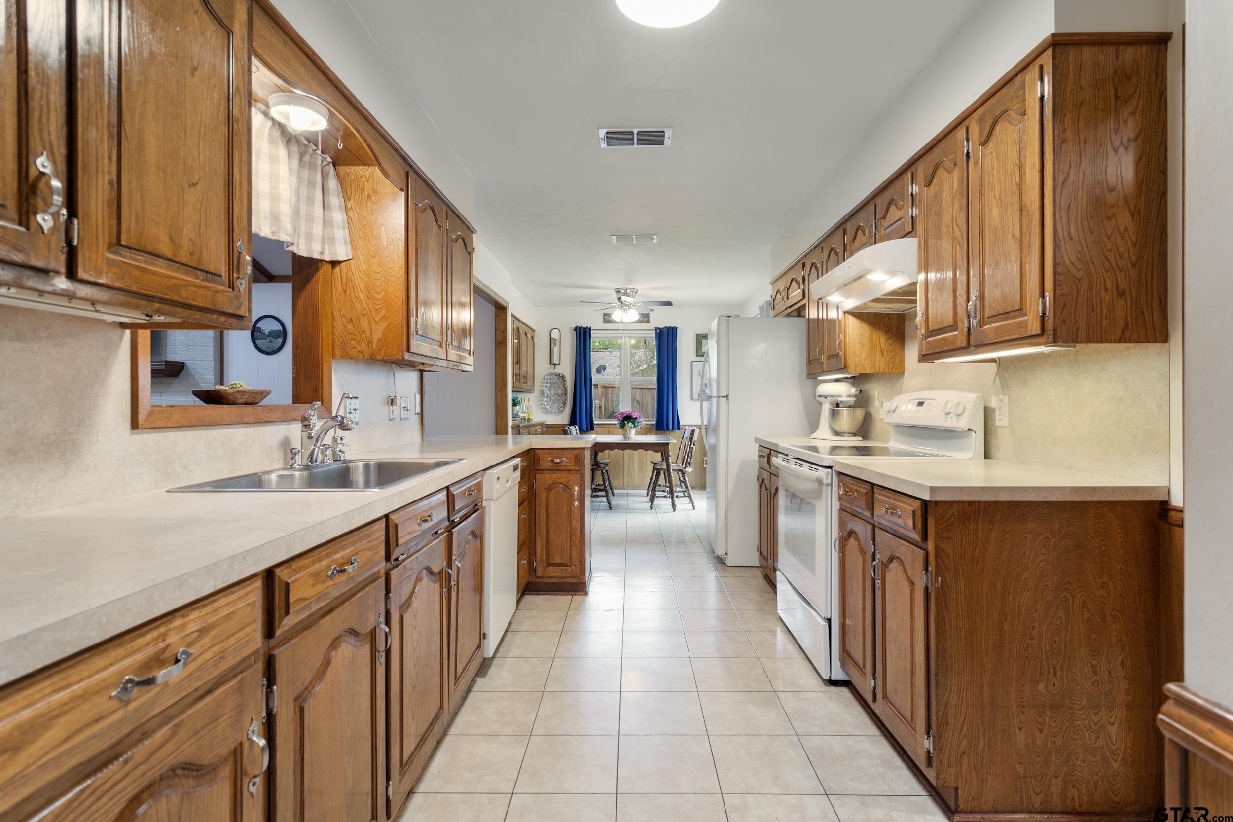 516 Ruthlynn Drive Longview, TX 75605 - Photo 10 of 34 a kitchen with stainless steel appliances granite countertop a sink and cabinets