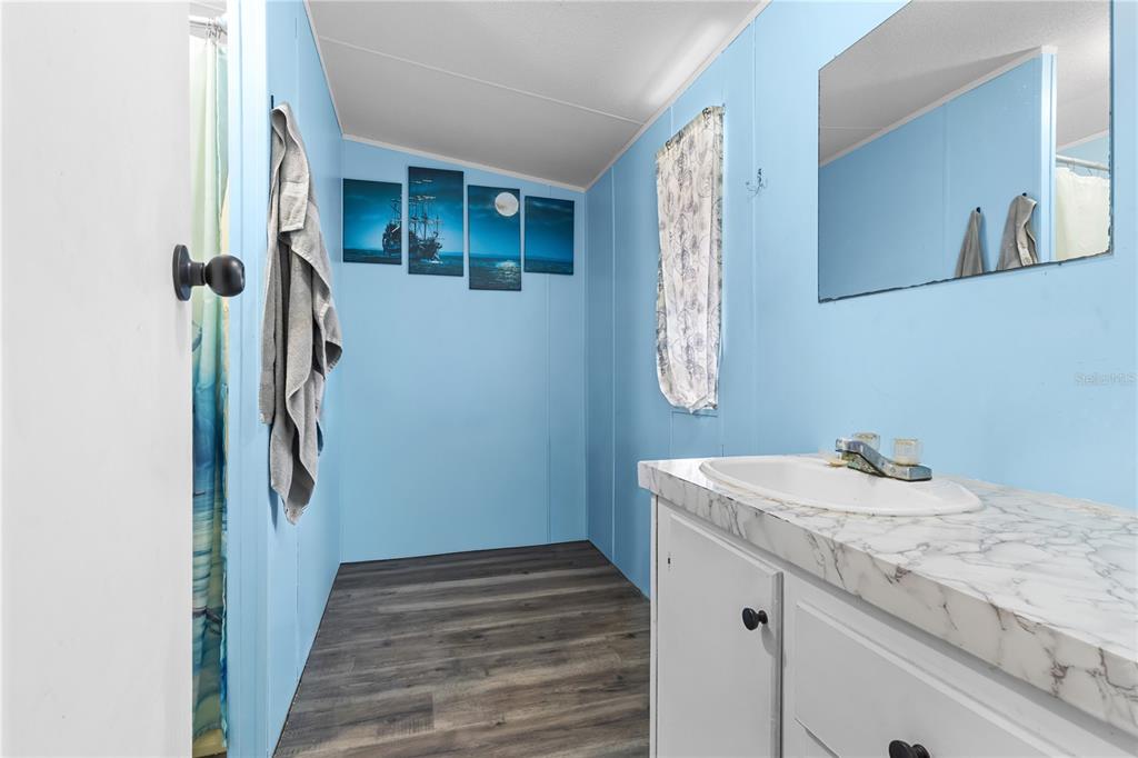 1650 Lyman Hendry Road, Unit 2 Perry, FL 32347 - Photo 13 of 26 a bathroom with a sink and mirror