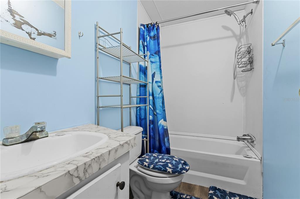 1650 Lyman Hendry Road, Unit 2 Perry, FL 32347 - Photo 3 of 26 a bathroom with a sink a toilet and shower