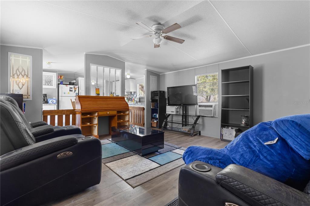 1650 Lyman Hendry Road, Unit 2 Perry, FL 32347 - Photo 6 of 26 a living room with furniture and a chandelier