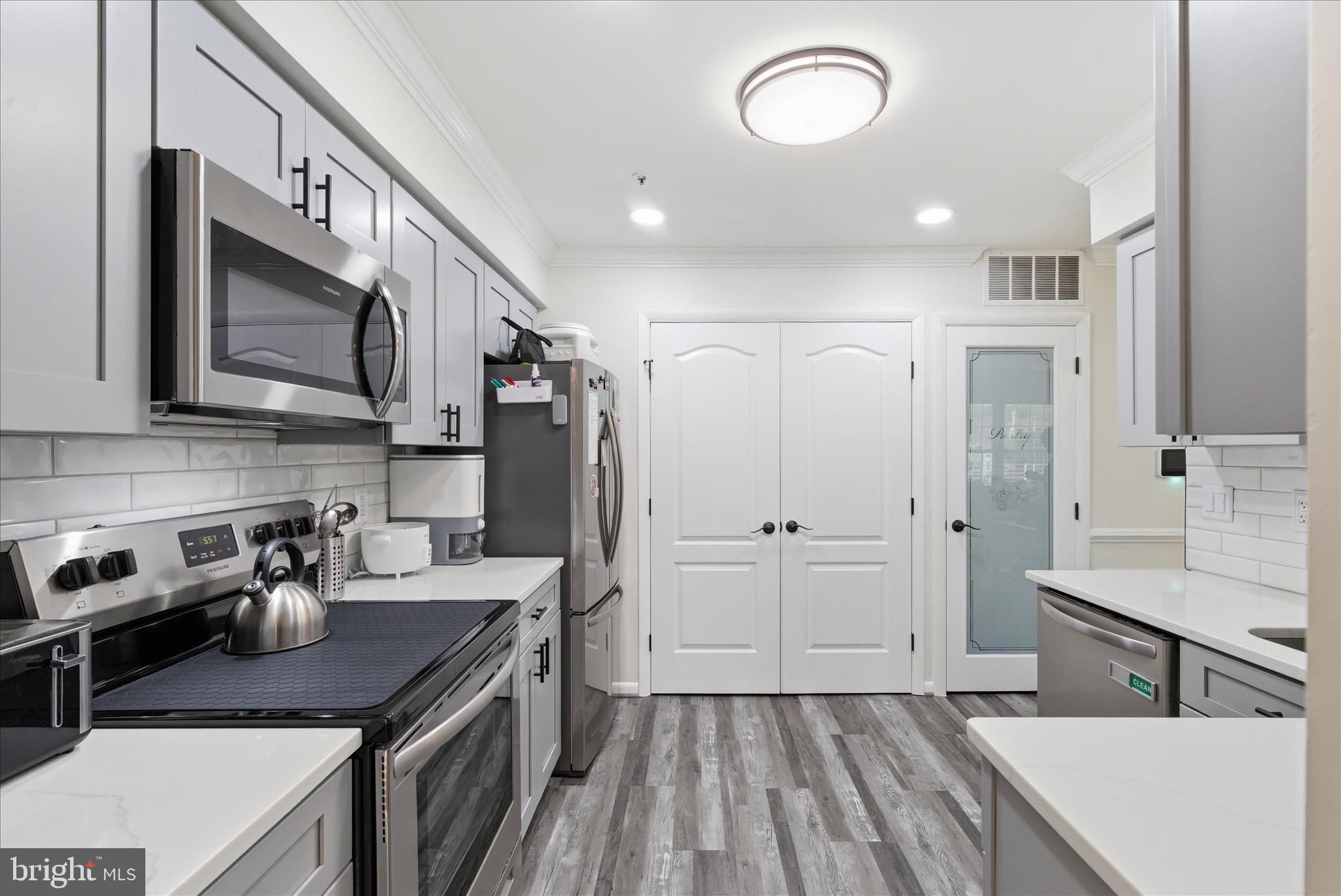 1008 Spring Valley Court Fort Washington, MD 20744 - Photo 8 of 25 a kitchen with kitchen island granite countertop a sink cabinets and stainless steel appliances