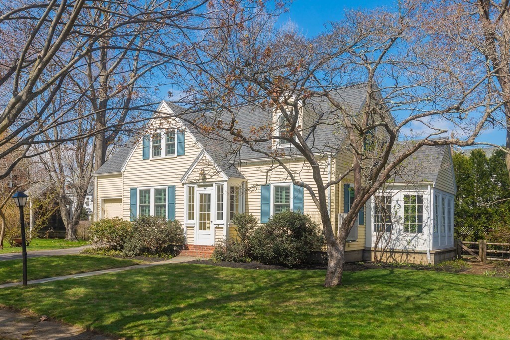 a front view of a house with a garden